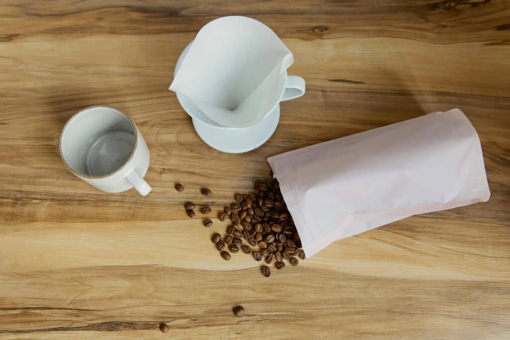 Coffee beans spilled out of a coffee storage bag. 